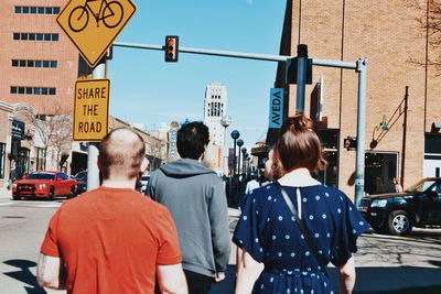 Rear view of people on city street