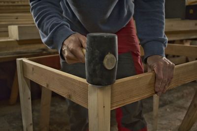 Midsection of man holding table