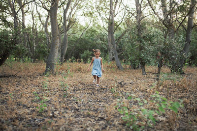 Boy running in forest