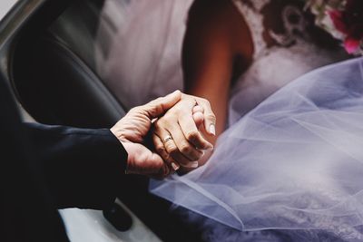 Close-up of couple holding hands