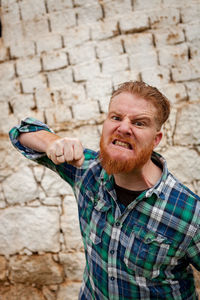 Portrait of man against wall