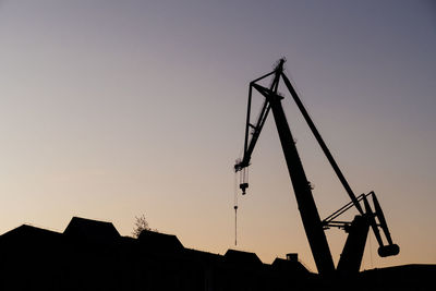 Low angle view of silhouette building against sky during sunset