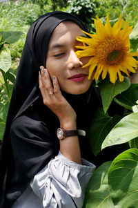 Beautiful woman with yellow flower