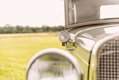 Close-up of vintage car on field