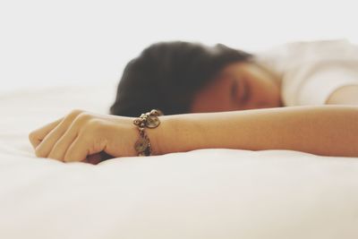 Portrait of woman lying on bed