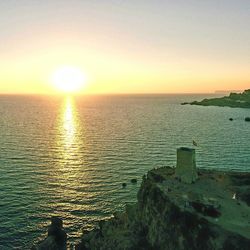 Scenic view of sea against clear sky during sunset