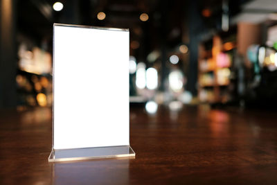 Close-up of illuminated light bulb on table