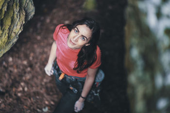 High angle portrait of smiling young woman standing in forest