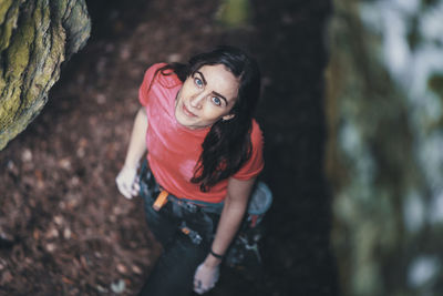 Portrait of smiling young woman in forest