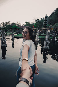 Portrait of smiling young woman in lake