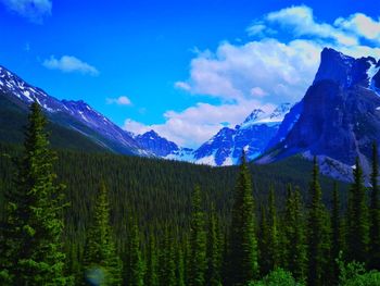 Scenic view of mountains against blue sky