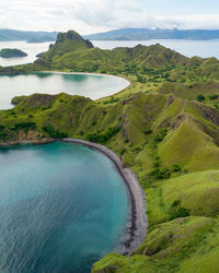 Scenic view of sea and mountains against sky