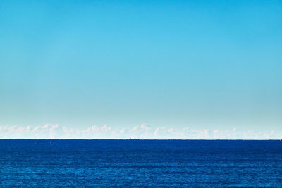 Scenic view of sea against blue sky