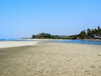 Scenic view of beach against blue sky