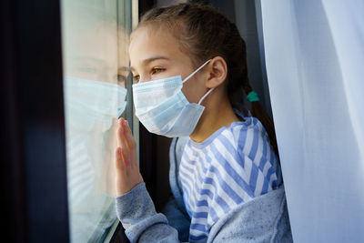 Portrait of cute girl in window