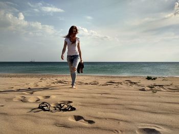 Full length of man on beach against sky