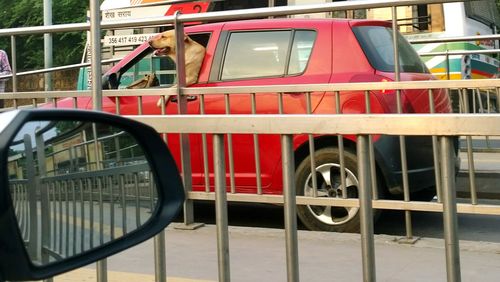 Reflection of red car on side-view mirror