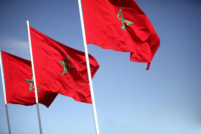 Low angle view of flag against blue sky