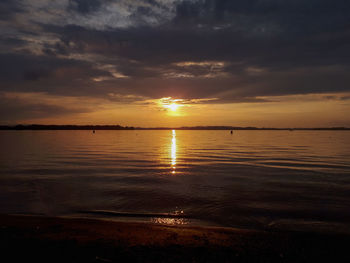 Scenic view of sea against romantic sky at sunset