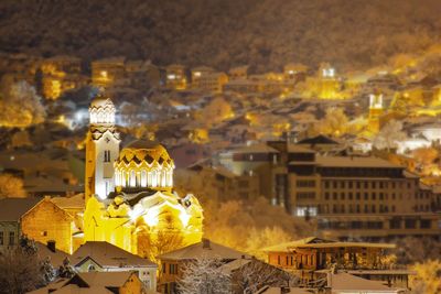 Illuminated buildings in city at night