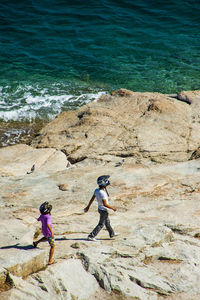 Woman standing on rocks at sea shore