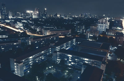 High angle view of city lit up at night