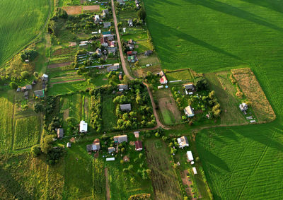 Country houses in the countryside. aerial view of roofs of green field with rural homes.