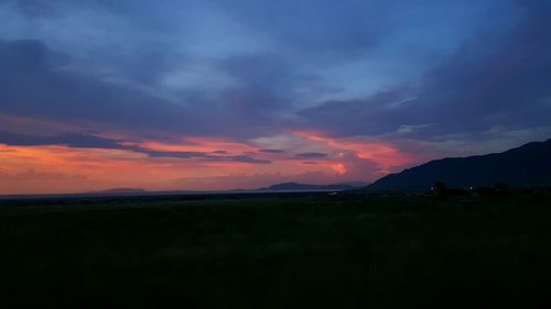 Scenic view of silhouette mountains against sky at sunset