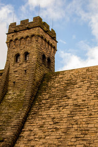 Low angle view of historical building against cloudy sky