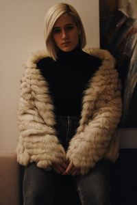 Portrait of young woman sitting at home