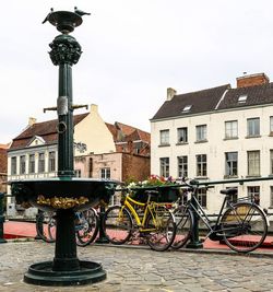 Bicycles against sky in city