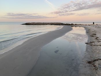 Scenic view of beach against sky during sunset