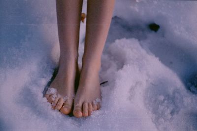 Low section of woman standing on beach