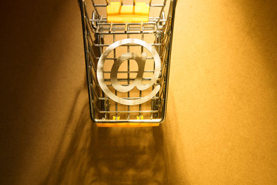 High angle view of illuminated lamp on table against wall