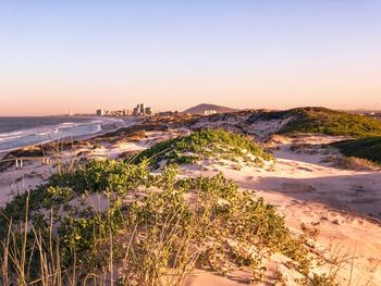 Scenic view of sea against clear sky during sunset