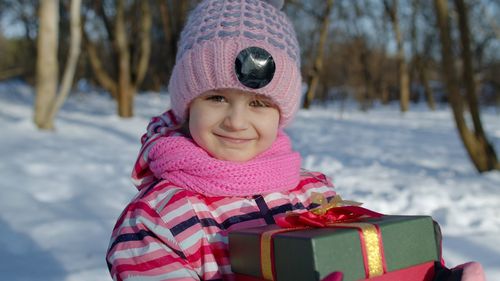 Portrait of a smiling girl in snow