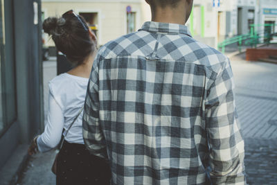 Rear view of couple standing outdoors