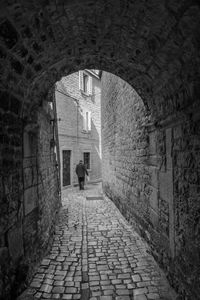 Man walking in corridor of building