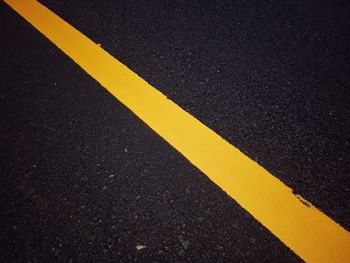 High angle view of yellow marking on road