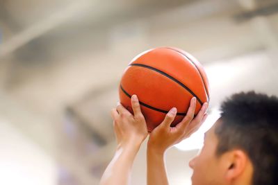 Midsection of man playing with ball