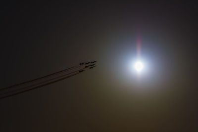 Low angle view of silhouette airplane against sky during sunset