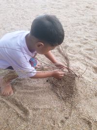 Full length of cute boy on sand at beach