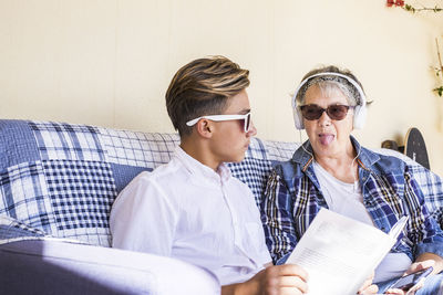 Grandmother listening music with grandson at home