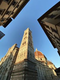 Low angle view of buildings against blue sky