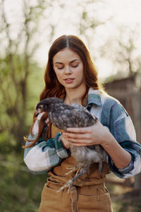 Beautiful woman holding hen