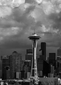 Modern buildings in city against cloudy sky