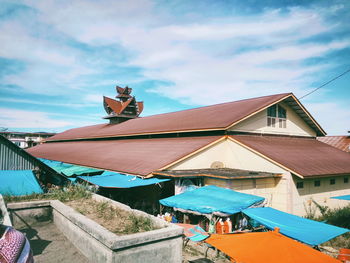 High angle view of houses in town against sky