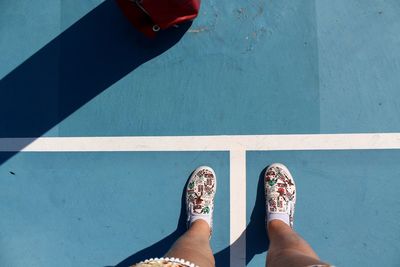 Low section of woman standing on tiled floor