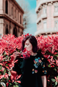 Woman standing by plants