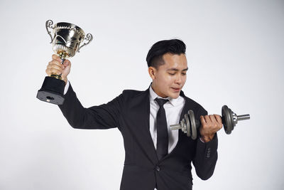 Man holding camera over white background